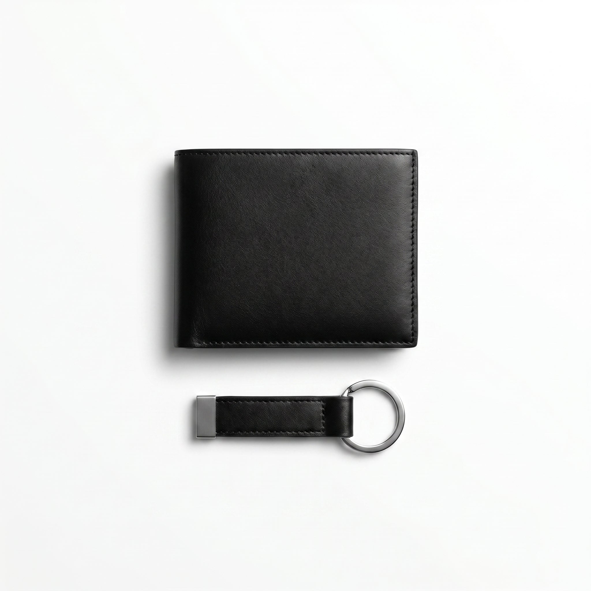 Straight studio layout view of the Calvin Klein mirror original black leather wallet back panel next to its standalone matching leather key ring