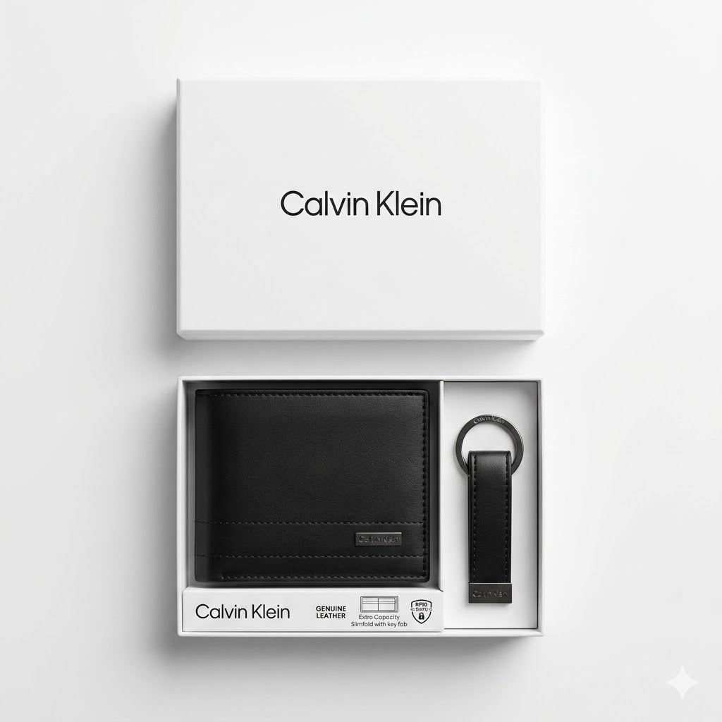 Top-down studio product photography of the Calvin Klein mirror original smooth black leather wallet and keychain set neatly resting inside its open white branded gift box
