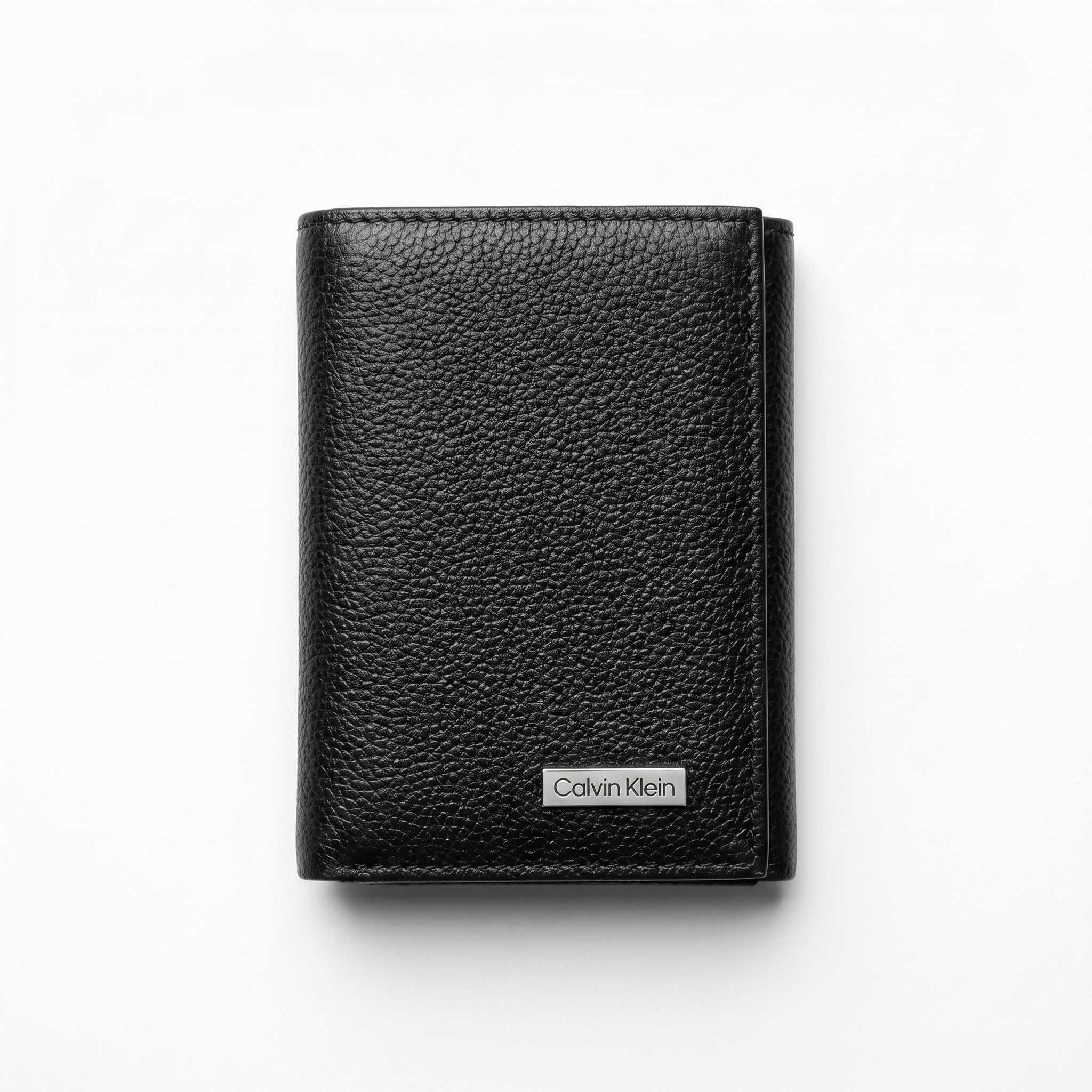 Straight front view product photograph of the Calvin Klein mirror original pebbled black leather trifold wallet showcasing the textured finish and silver logo plate
