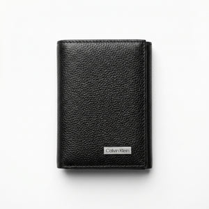 Straight front view product photograph of the Calvin Klein mirror original pebbled black leather trifold wallet showcasing the textured finish and silver logo plate