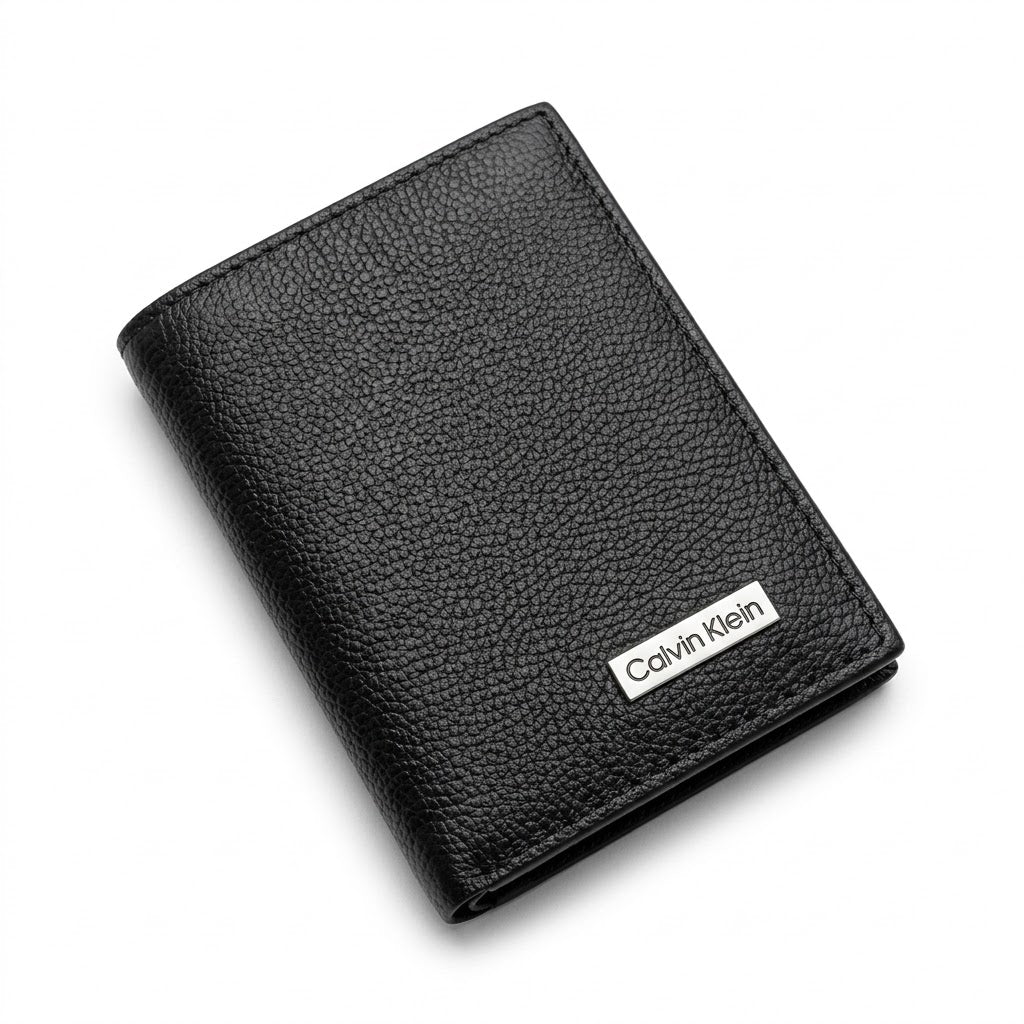 Straight front view product photograph of the Calvin Klein mirror original pebbled black leather trifold wallet showcasing the textured finish and silver logo plate