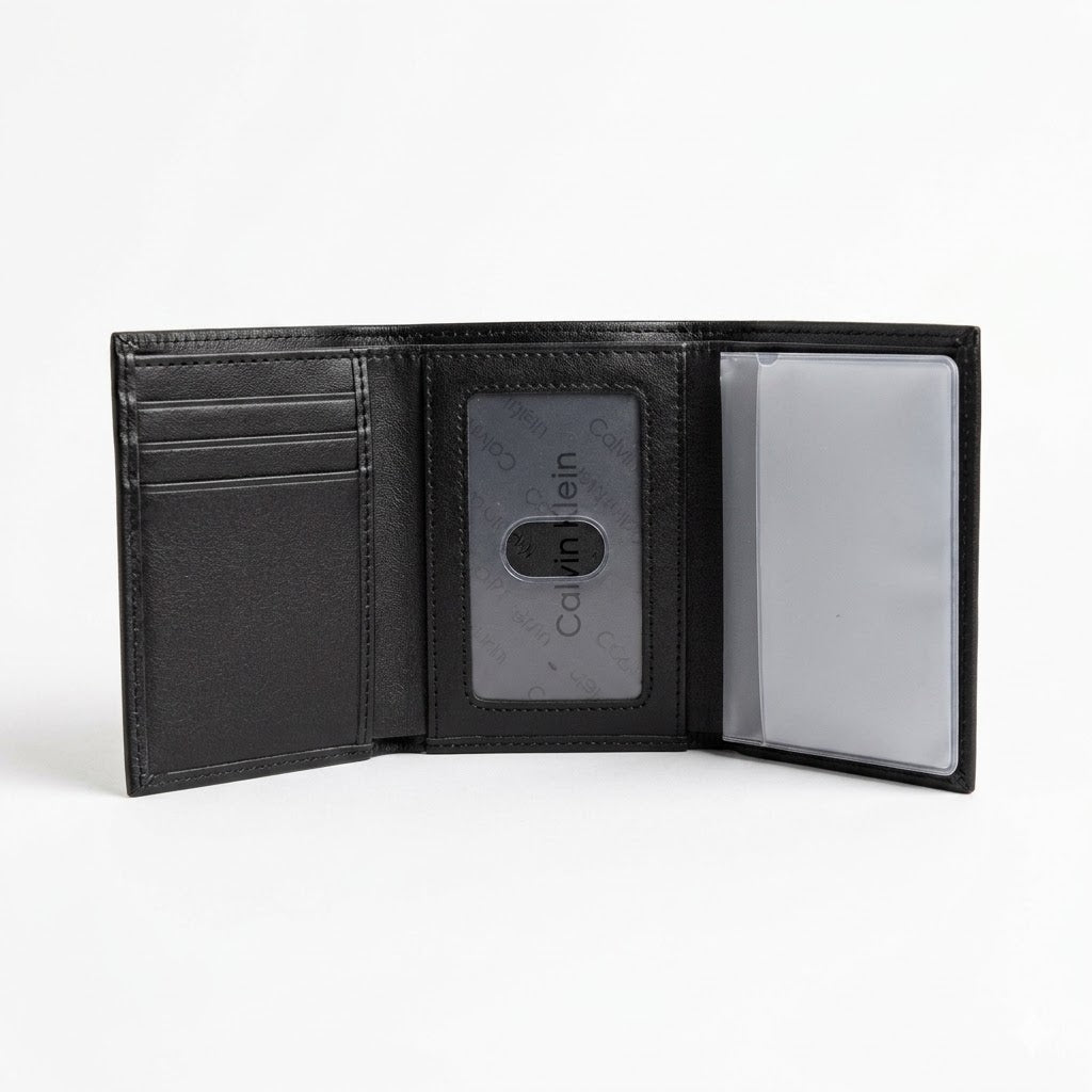 Live smartphone photograph of the opened Calvin Klein mirror original leather trifold wallet showcasing the internal layout, clear ID window, and transparent card booklet slots