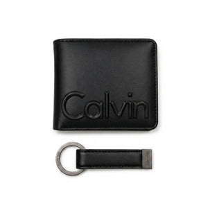 Professional angled studio photograph of the Calvin Klein mirror original smooth black leather wallet front panel showing the debossed Calvin text logo
