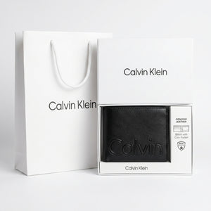 Full premium packaging presentation of the Calvin Klein mirror original smooth black leather wallet with its white gift box and matching shopping bag