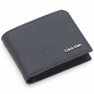 Perspective view of a standing Calvin Klein men's navy blue saffiano leather bifold wallet showcasing the textured finish and silver metal logo on the front