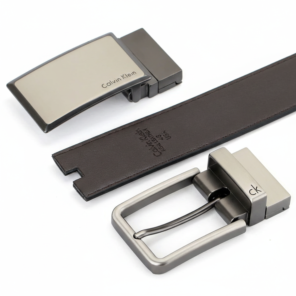 Close-up view of the Calvin Klein reversible leather belt set in brown, showcasing both the classic pin buckle and the modern plaque buckle