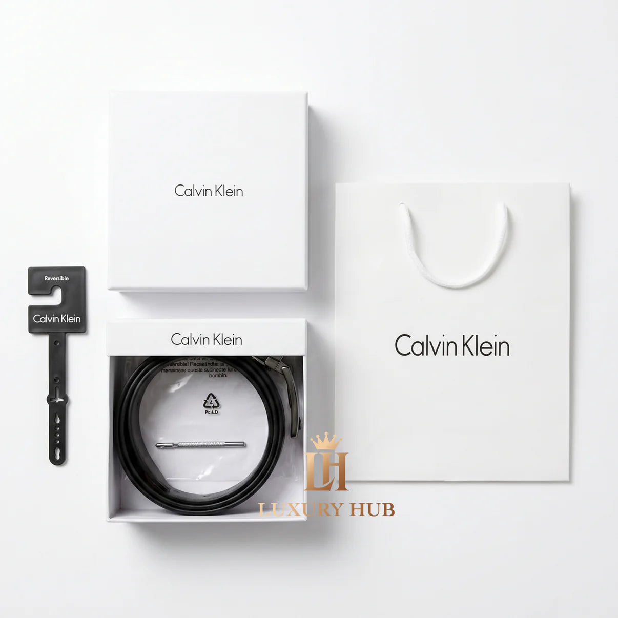 Top view product photography of the Calvin Klein reversible leather belt set presented in its signature white gift box
