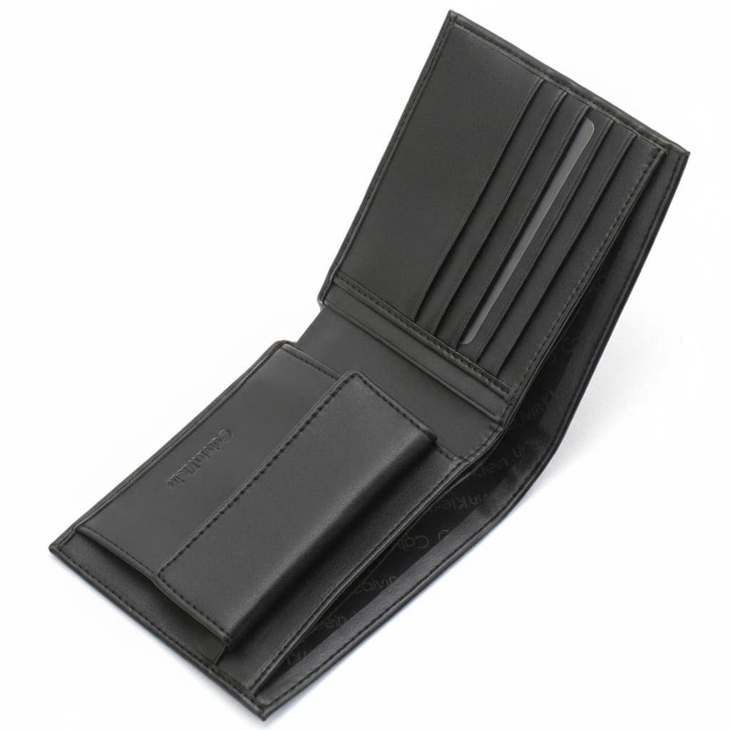 Angled interior view of an open Calvin Klein men's black leather wallet showcasing a snap-button coin pocket and multiple card slots