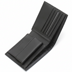Angled interior view of an open Calvin Klein men's black leather wallet showcasing a snap-button coin pocket and multiple card slots