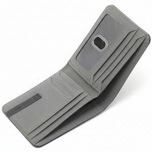 Angled interior view of an open Calvin Klein men's wallet showcasing the distinctive grey leather finish, multiple card slots, and an attached passcase with a clear ID window