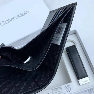 Hand holding open Calvin Klein wallet showing coin pocket and card slots