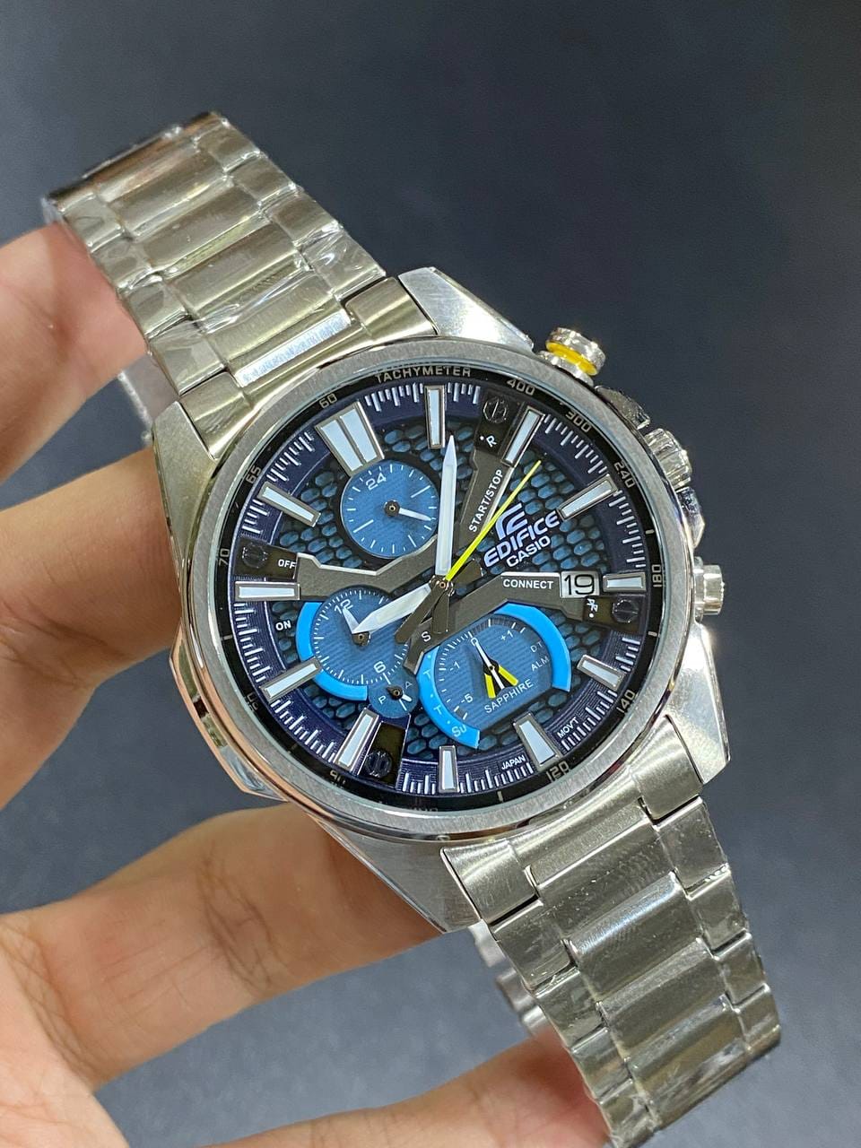 Casio Edifice EQB-1200D-2A men's chronograph watch, blue dial, silver-tone stainless steel bracelet – in hand view