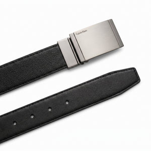 Detailed view of the Calvin Klein double-face leather belt showing the reversible black and brown premium leather sides