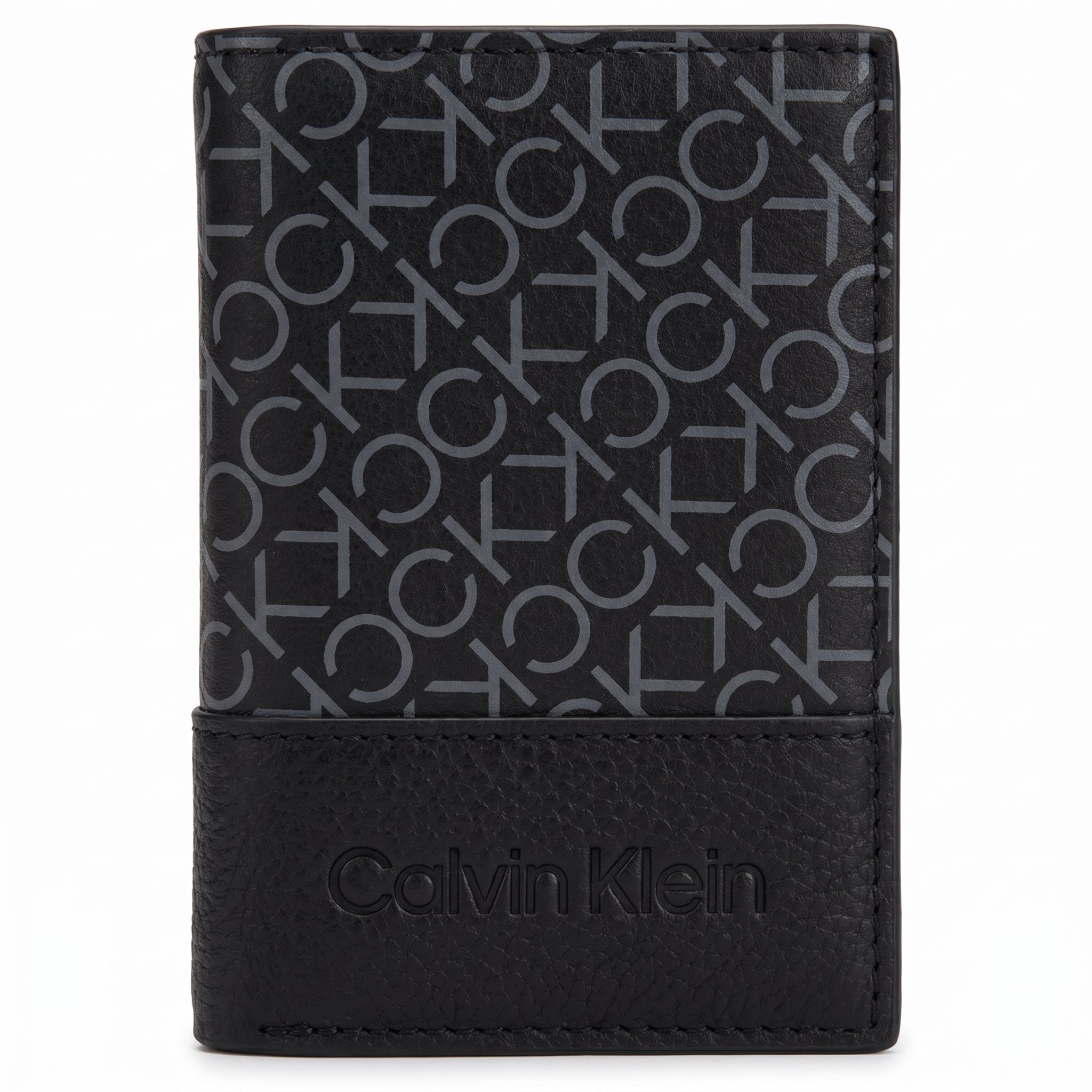 Macro close-up view showing the grained leather texture and precision engraved Calvin Klein branding at the bottom of the wallet