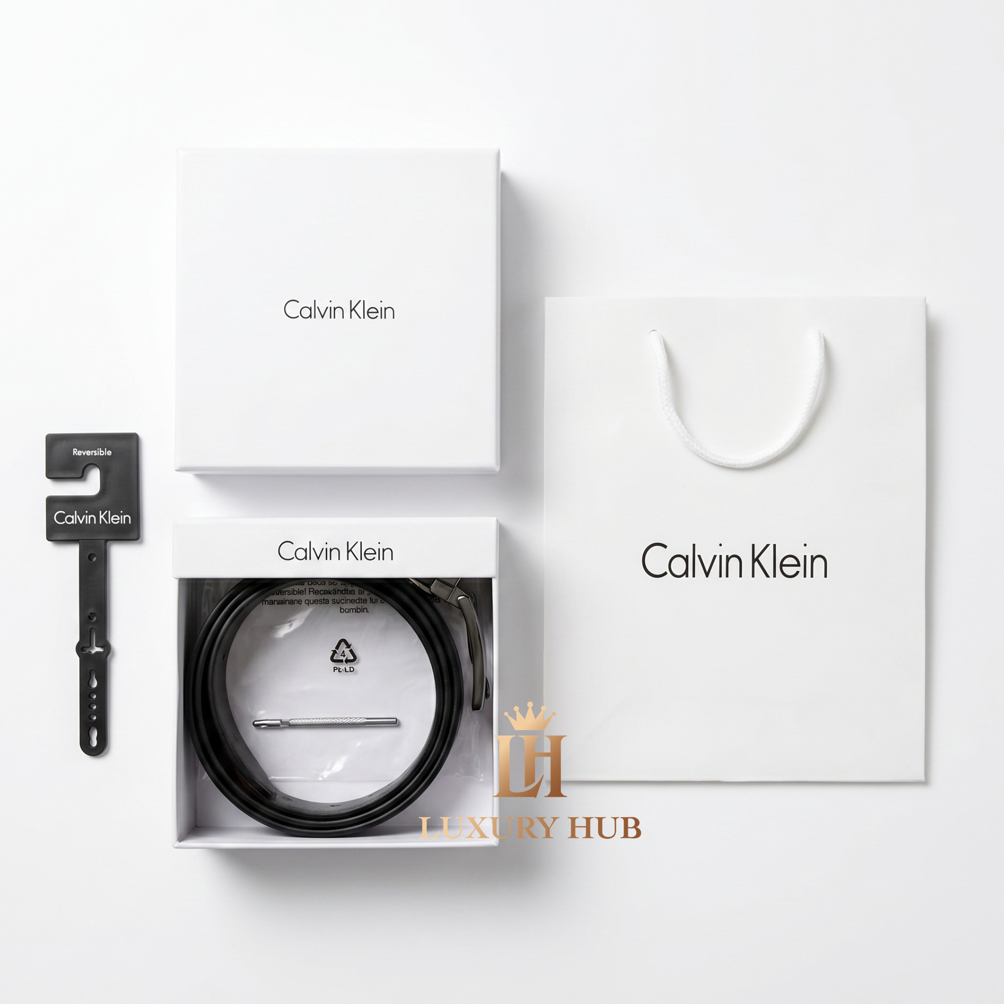 Top view product photography of Calvin Klein reversible leather belt presented in its signature white gift box