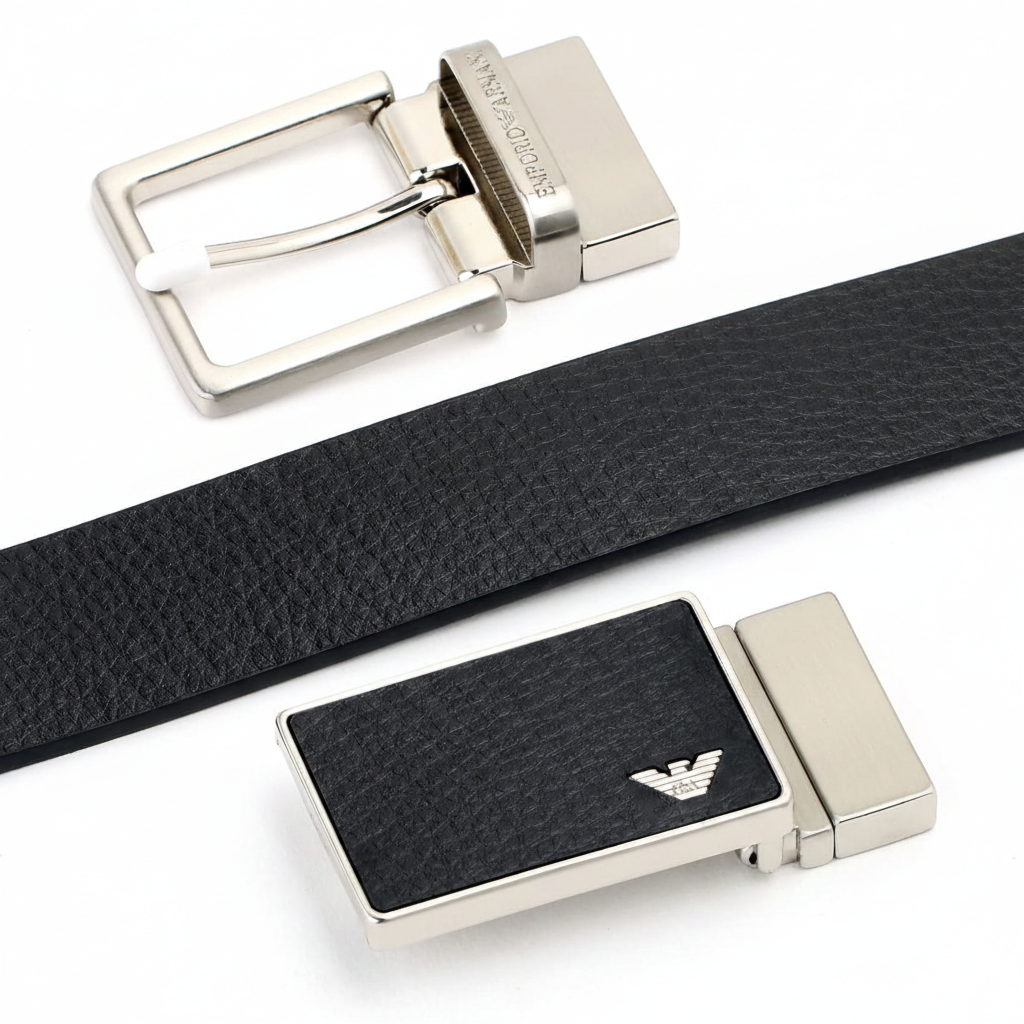 Close-up view of two premium Emporio Armani metal buckles: a modern plaque buckle with the iconic eagle logo and a classic pin buckle with engraved branding