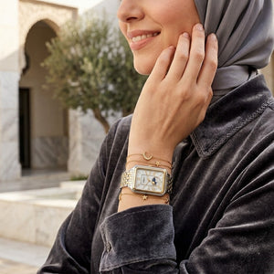 Lifestyle photo of Fossil Raquel ES5399 showing the rectangular two-tone watch on a woman's wrist