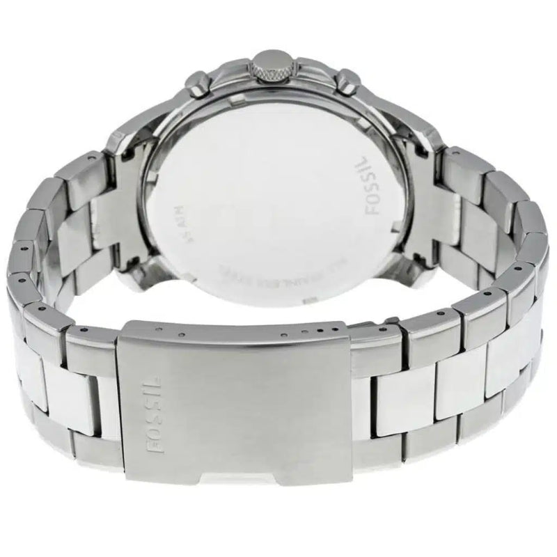 The back view of a stainless steel wrist watch with a metal link bracelet, showing the brushed silver case back and clasp engraved with the Fossil brand name.