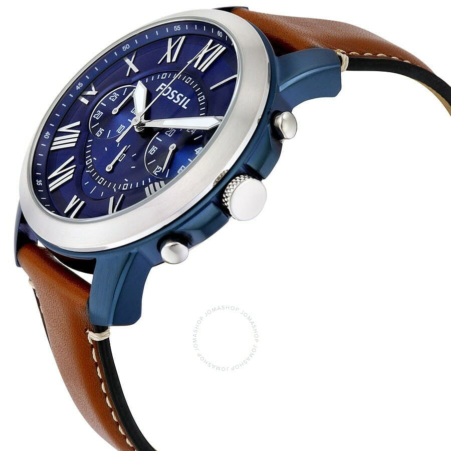 Fossil watch with blue face and brown leather strap on a white background