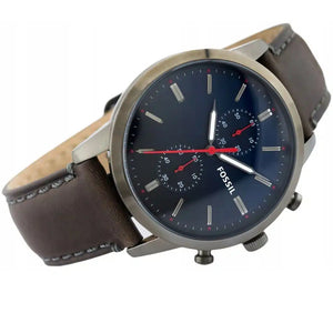 Fossil watch with brown leather strap and blue dial on a white background
