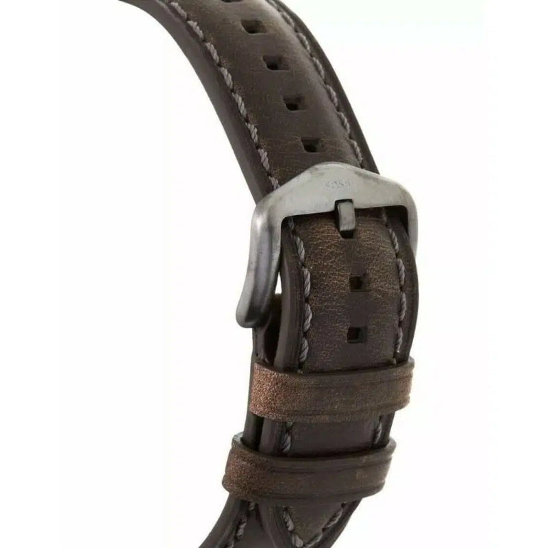 A close-up of a dark brown leather watch strap with white contrast stitching and a silver-tone metal buckle, shown against a plain white background.