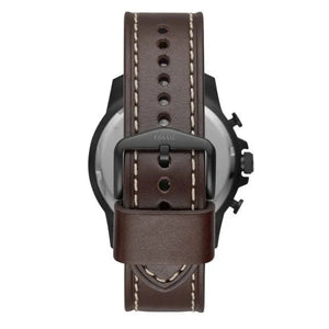 A close-up rear view of a watch with a dark brown leather strap, featuring light contrast stitching and a black buckle with the brand name 'FOSSIL' embossed on it, set against a plain white background.