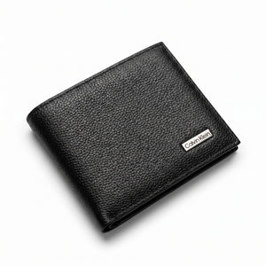 Professional angled studio photograph of the sleek Calvin Klein mirror original pebbled black leather bi-fold wallet