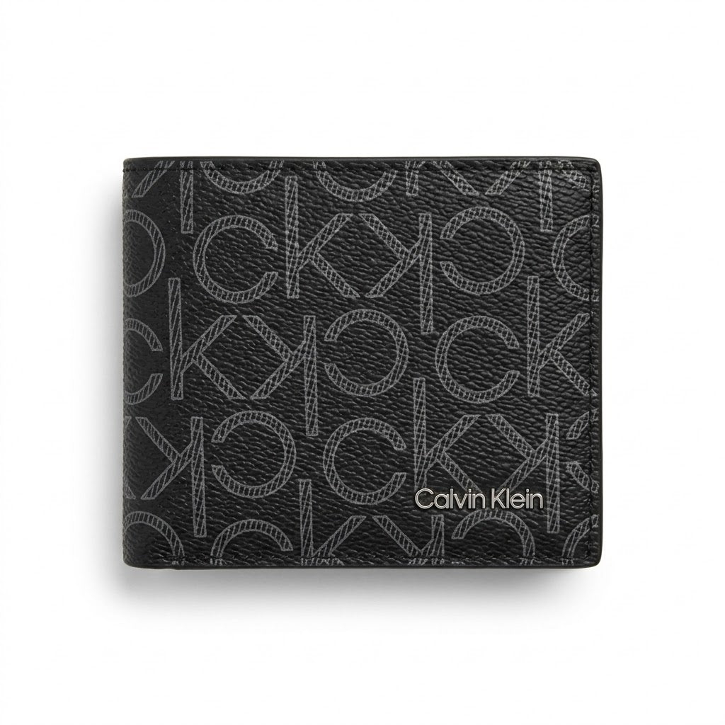 Straight front view product photography of the Calvin Klein black leather wallet showcasing the grey printed monogram pattern and corner silver script logo