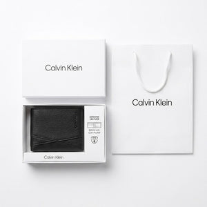 Flat lay presentation of the Calvin Klein mirror original saffiano leather wallet with original packaging white gift box and shopping bag