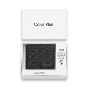 Top-down studio photograph of the Calvin Klein grey monogram printed leather wallet neatly presented inside its open premium white gift box