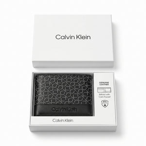 Top-down studio photograph of the Calvin Klein smooth black leather trifold wallet presented inside its open premium white gift box