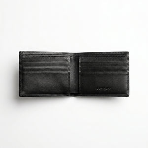 Top-down studio photograph of the Calvin Klein smooth black leather trifold wallet presented inside its open premium white gift box