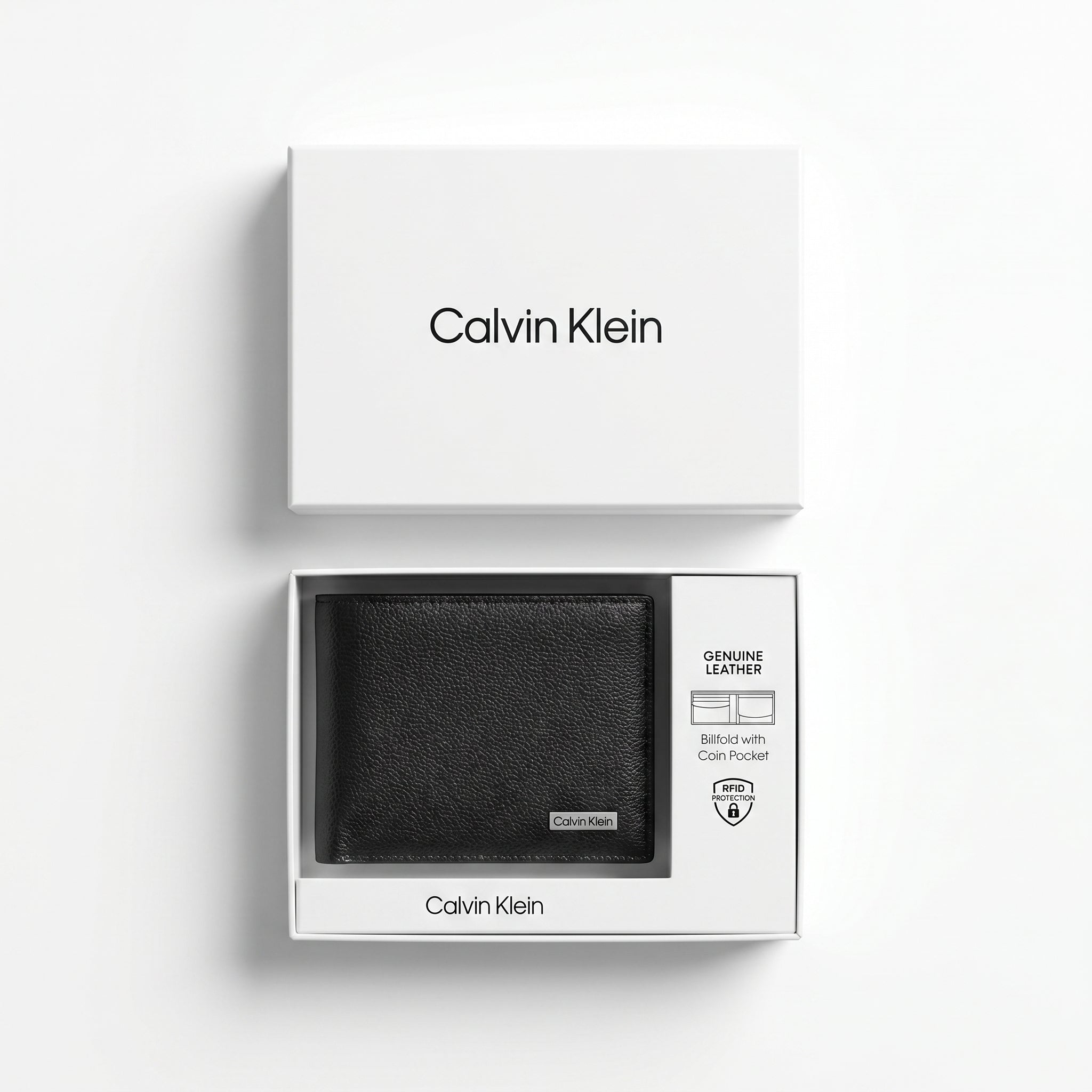 Top-down studio photograph of the Calvin Klein pebbled black leather wallet neatly placed inside its open premium white gift box