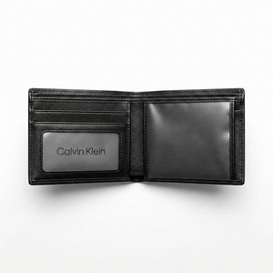Angled studio shot of the Calvin Klein mirror original black leather trifold wallet emphasizing fine stitching and smooth premium texture