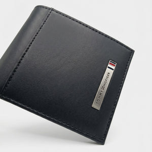 Professional angled studio photograph of the sleek Tommy Hilfiger mirror original smooth leather bi-fold wallet