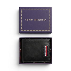 Top-down studio photograph of the Tommy Hilfiger saffiano leather trifold wallet neatly placed inside its open navy gift box