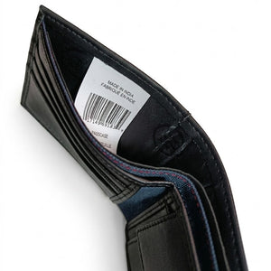 Inside view of the Tommy Hilfiger wallet currency compartment showing the white authenticity label, barcode, and inner lining