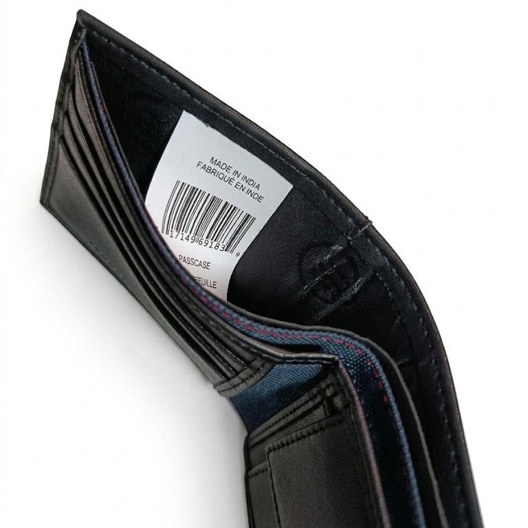 Inside view of the Tommy Hilfiger wallet currency compartment showing the white authenticity label, barcode, and inner lining