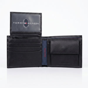 Interior view of the Tommy Hilfiger leather wallet showcasing card slots, a clear flip-up ID window, and a snap button coin pocket
