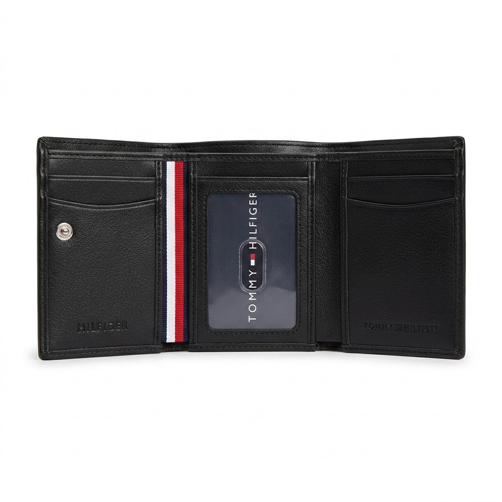 Internal trifold layout view of the Tommy Hilfiger leather wallet showcasing multiple card slots, snap button coin pocket, and clear ID window