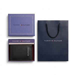 Full presentation of the Tommy Hilfiger mirror original smooth black leather trifold wallet set with its navy gift box and shopping bag