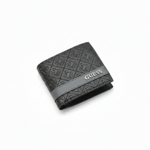 Close-up angled view of a Guess men's black genuine leather wallet highlighting the all-over embossed logo pattern and a smooth center band with silver metal Guess lettering