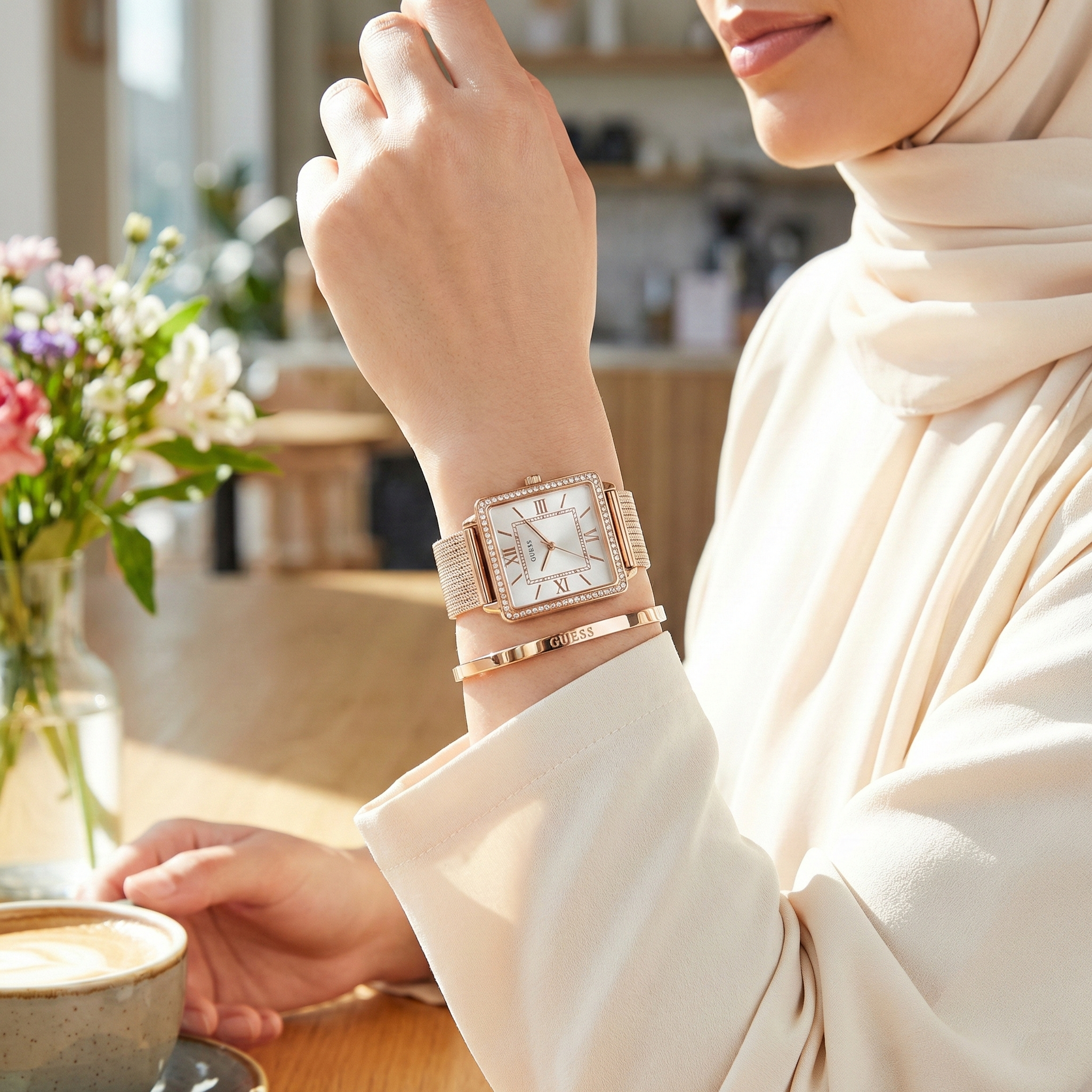 Female model wearing Guess Chelsea W0826L3 rose gold watch with a sophisticated office outfit