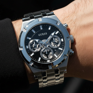 Man wearing Guess Continental GW0260G1 silver watch with a smart shirt and blazer