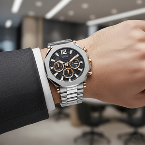 Male model wearing Guess Edge GW0539G1 silver and rose gold watch with a smart casual outfit