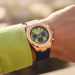 Close up shot of Guess Empire GW0583G3 watch on wrist showing the textured green dial and blue sub-dials