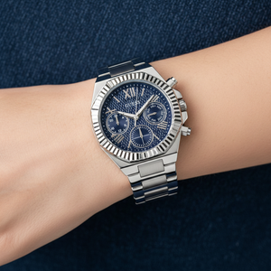 Close up shot of Guess GW0769L1 watch on wrist showing the textured denim dial and fluted bezel