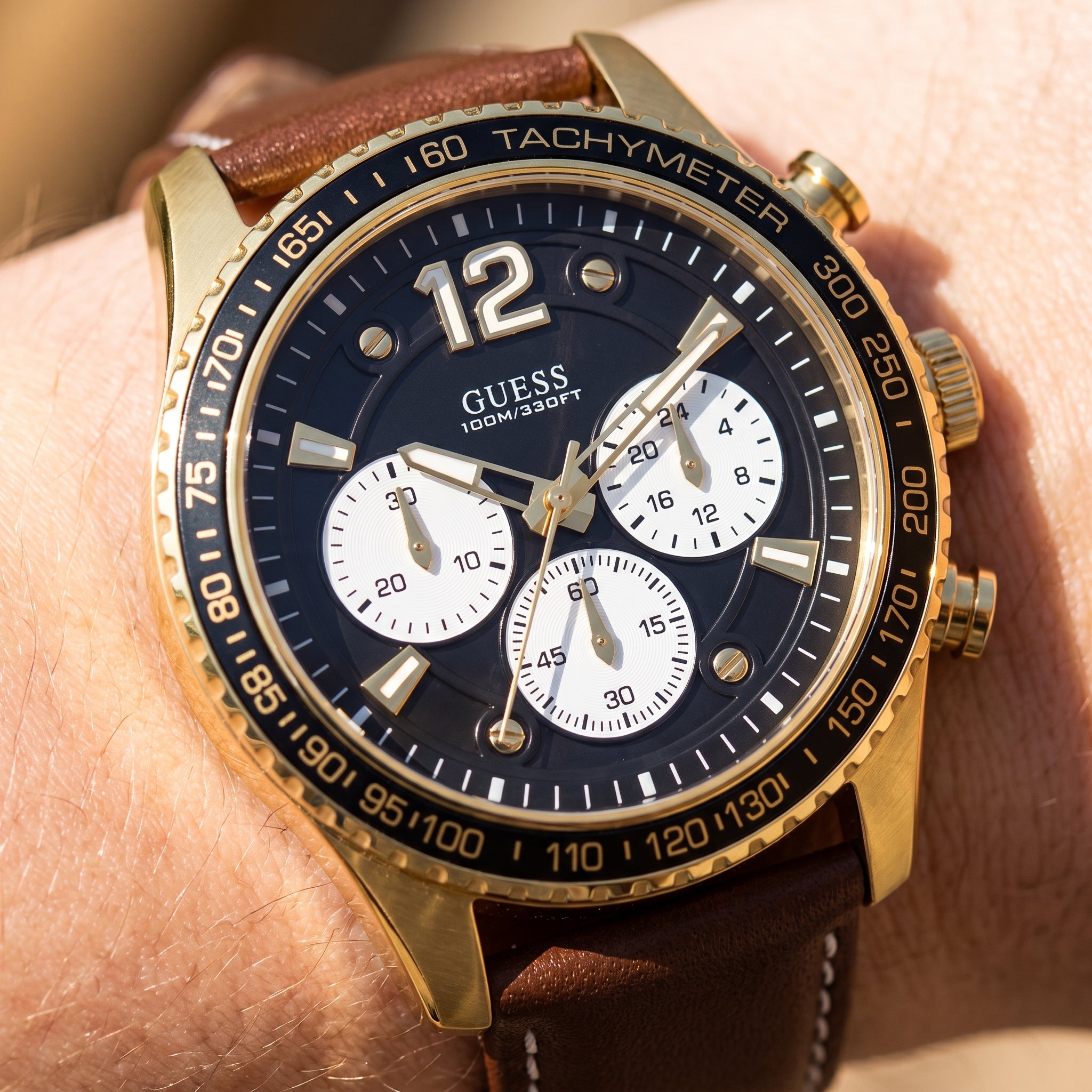 Wrist shot of Guess Fleet W0970G2 watch showing the brown leather band