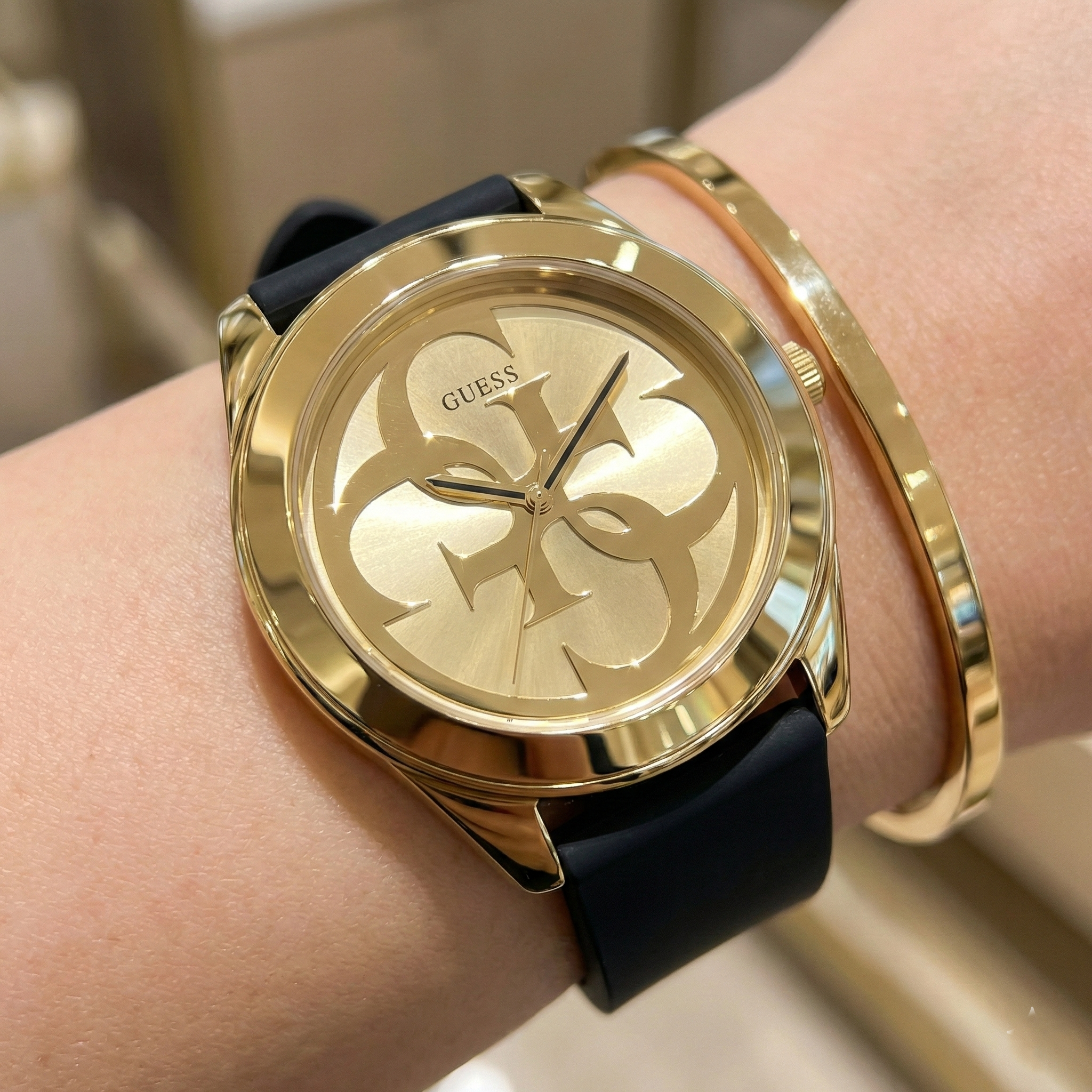 Close up shot of Guess G-Twist W0911L3 watch on wrist showing the interlocking 4G logo and gold hands