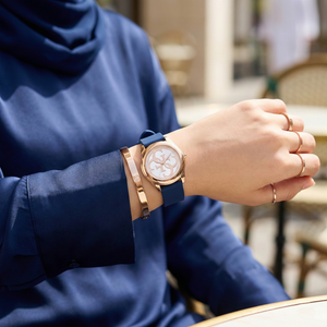 Female model wearing Guess G-Twist W0911L6 rose gold and blue watch with a casual outfit